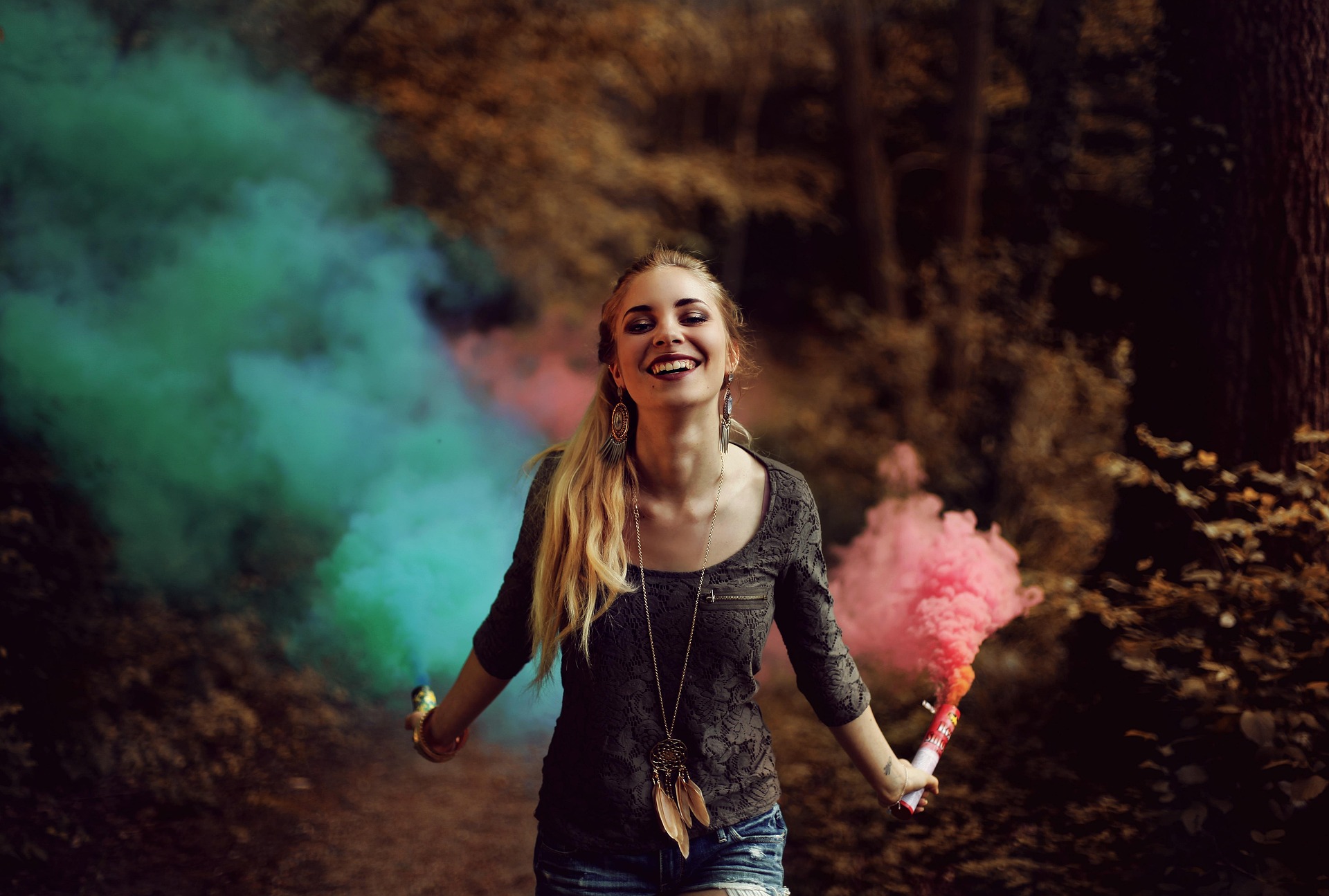 woman with dreadlocks, colorful clouds in the background