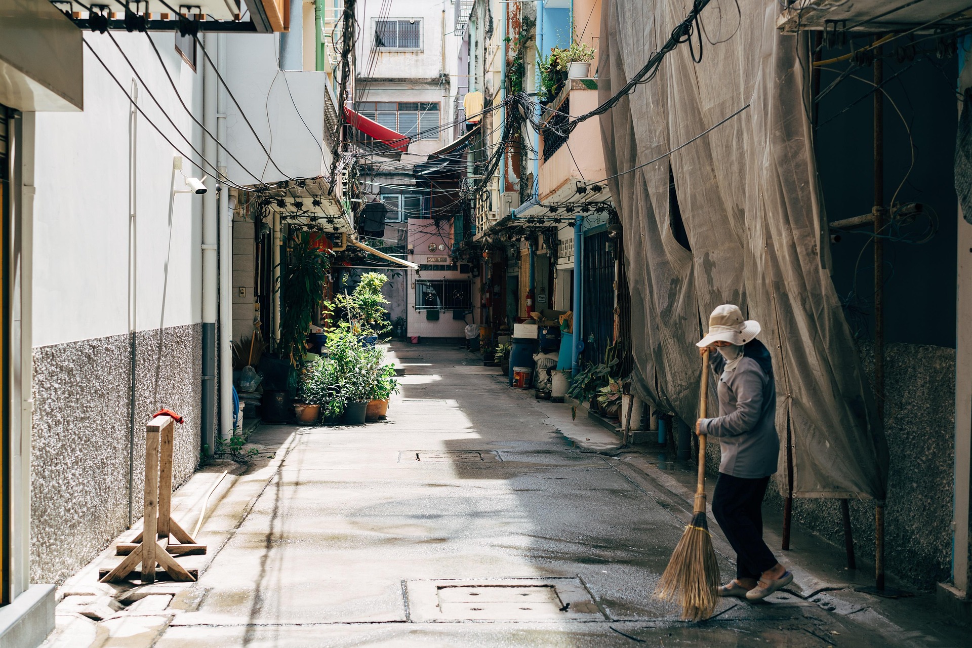 woman sweeping empty street